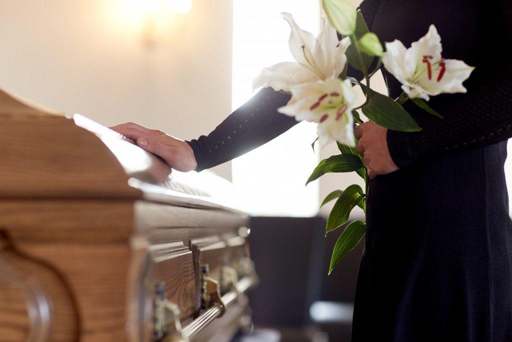 Woman holding flower at a funeral