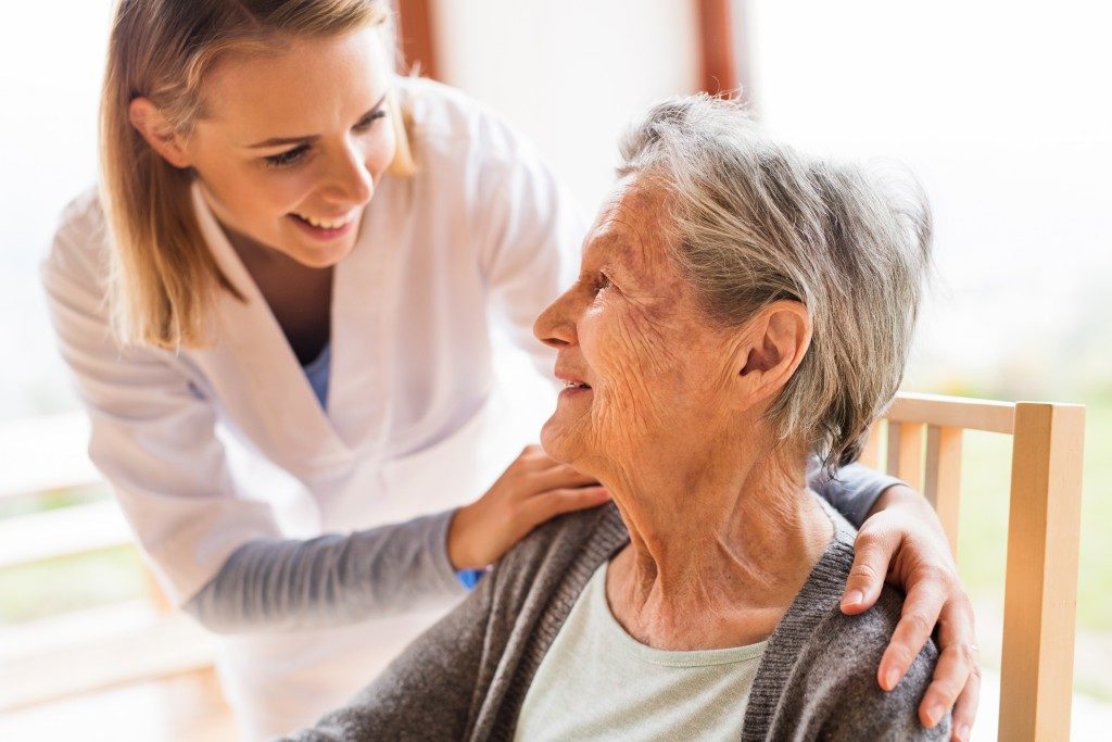 nurse taking care of an elderly patient