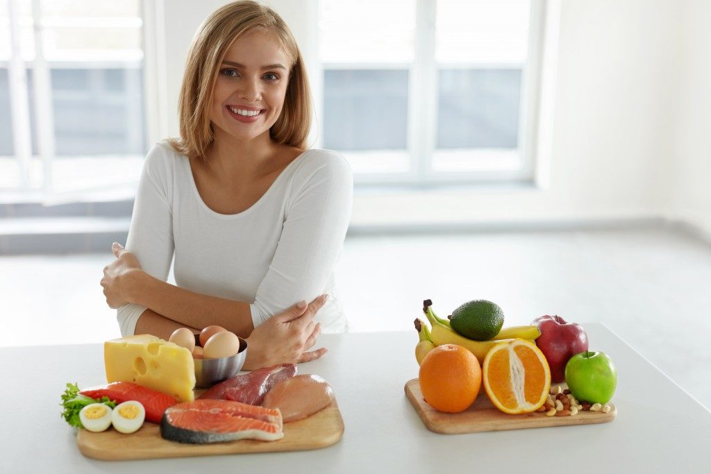 woman with healthy food on the table