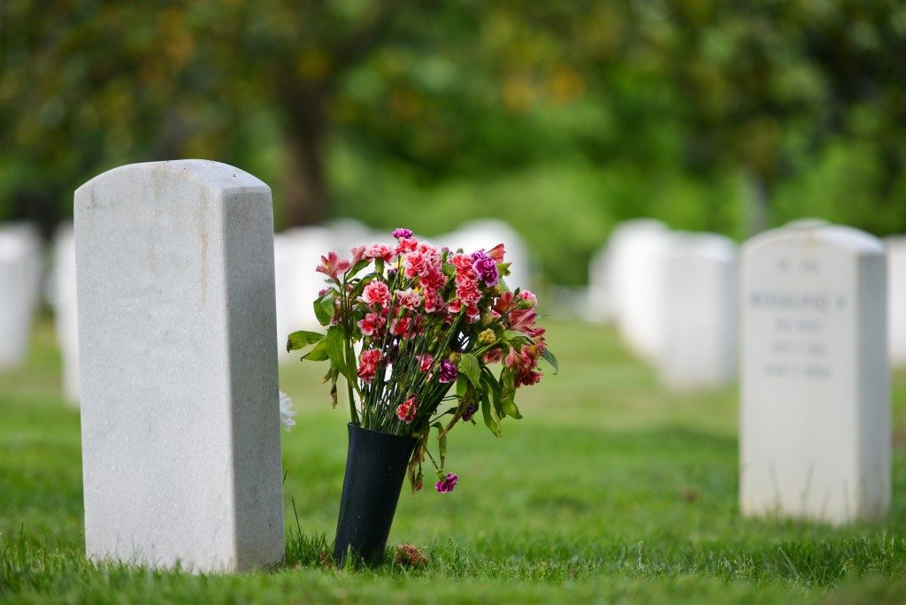 headstone with flowers beside it