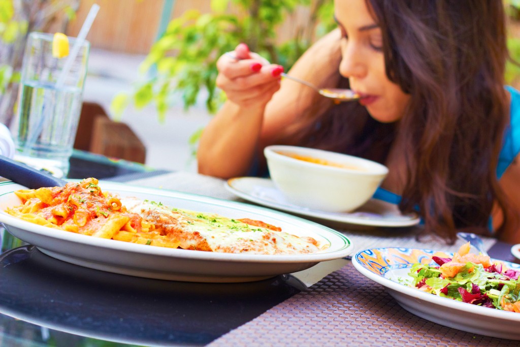 woman binge eating at a restaurant